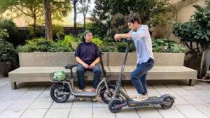Alt text: "Riders comparing modern electric scooters in the city, featuring sleek designs and powerful performance, with the fastest e scooter ideal for urban commuting and everyday travel."