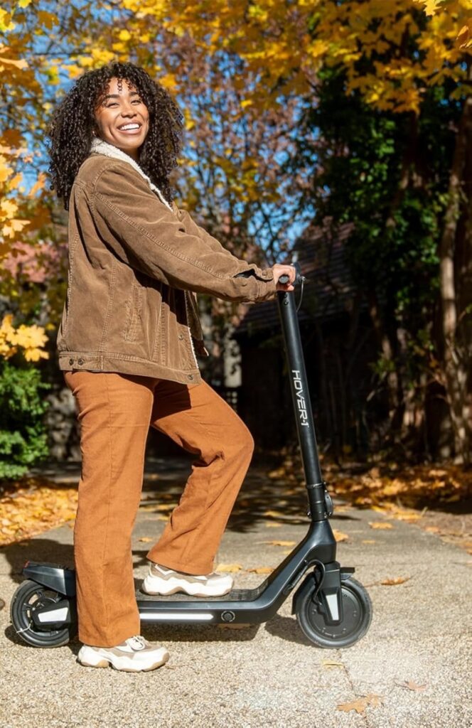 Teenager riding a HOVER-1 NEO X electric scooter on a sunny autumn day — one of the best electric scooters for kids and teenagers, featuring a lightweight frame and sleek modern design for smooth rides.